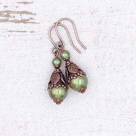 Earrings with iridescent olive green pearls and antiqued copper woodland-themed metal